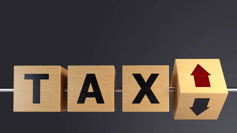 wooden cubes spelling out tax